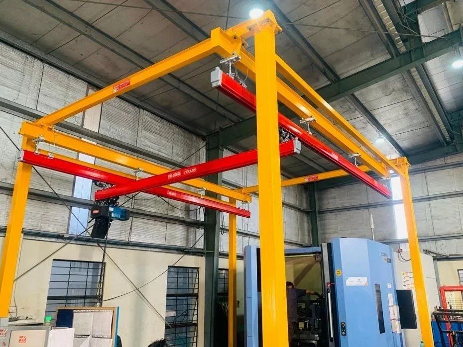 GS Tool & Components floor-mounted X-Y rail gantry system installed next to a CNC machining center